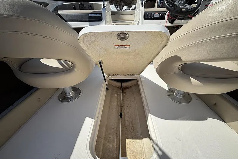 Slide: The Image of Interior view of a 2016 Bayliner 185 Bowrider boat with open storage compartment. - 15