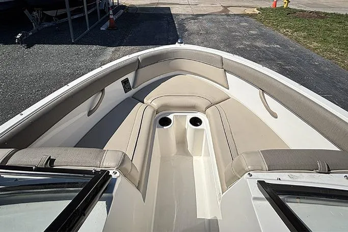 Slide: The Image of 2016 Bayliner 185 Bowrider boat interior with beige seating and cup holders. - 16
