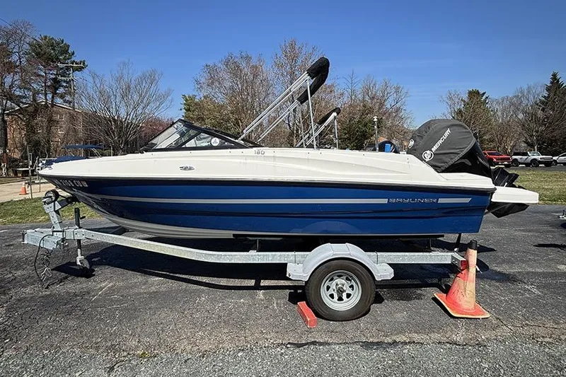 Slide: The Image of 2016 Bayliner 185 Bowrider boat on trailer, parked outdoors. - 3