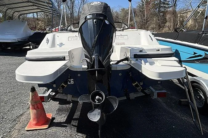 Slide: The Image of 2016 Bayliner 185 Bowrider boat, rear view, parked outdoors with motor and propeller visible. - 4