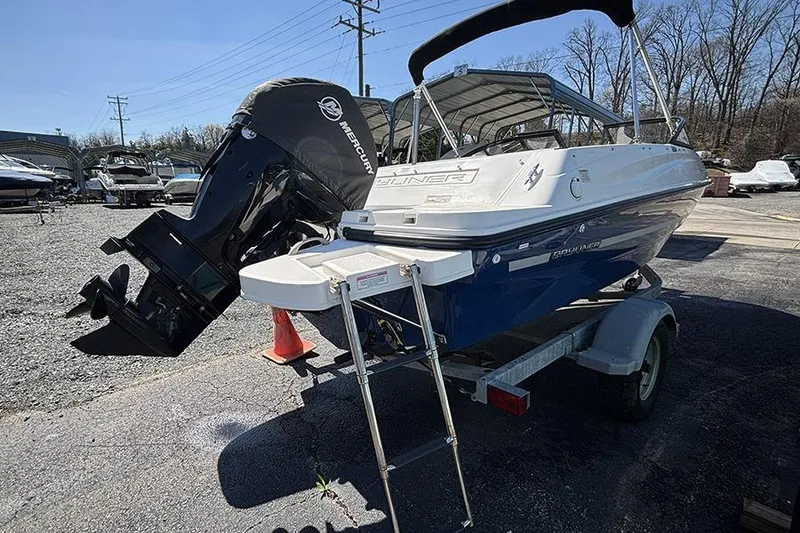 Slide: The Image of 2016 Bayliner 185 Bowrider on trailer with Mercury outboard motor in a boatyard. - 5