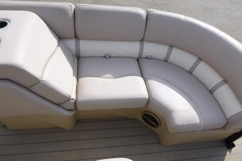 Slide: The Image of 2018 Bennington 24 SSRX boat seating with beige upholstery and cup holder. - 10