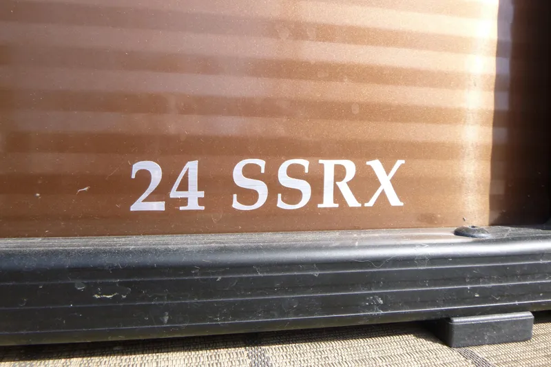 Slide: The Image of Close-up of 2018 Bennington 24 SSRX model name on brown surface. - 17