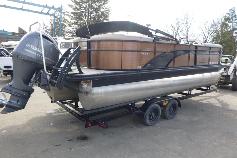 Slide: The Image of 2018 Bennington 24 SSRX pontoon boat with Yamaha outboard motor on trailer. - 2