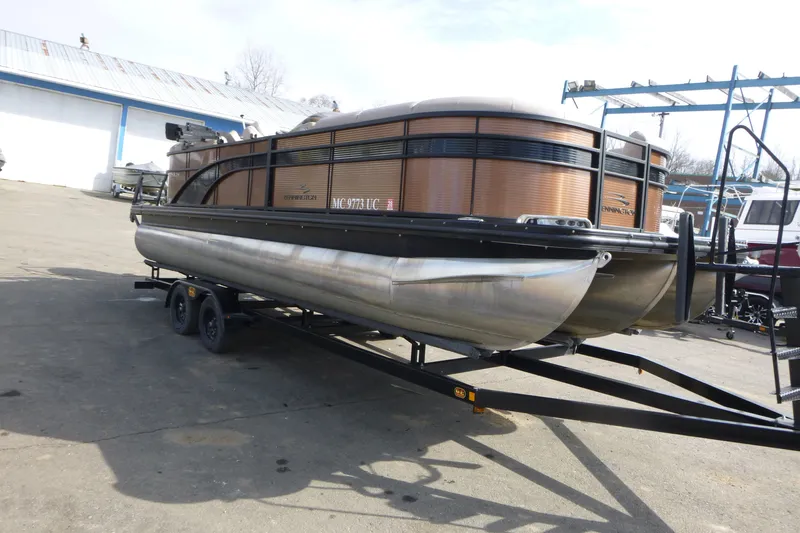 Slide: The Image of 2018 Bennington 24 SSRX pontoon boat on trailer in outdoor setting. - 3