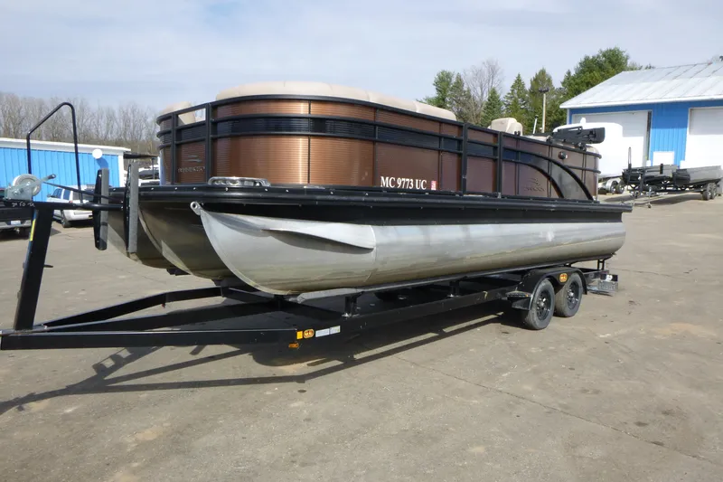 Slide: The Image of 2018 Bennington 24 SSRX pontoon boat on trailer in outdoor setting. - 4