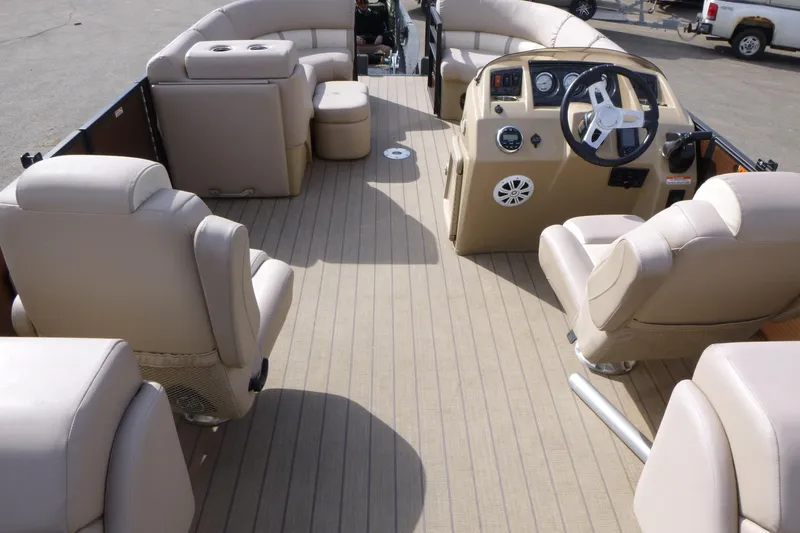 Slide: The Image of 2018 Bennington 24 SSRX pontoon boat interior with beige seating and steering console. - 7