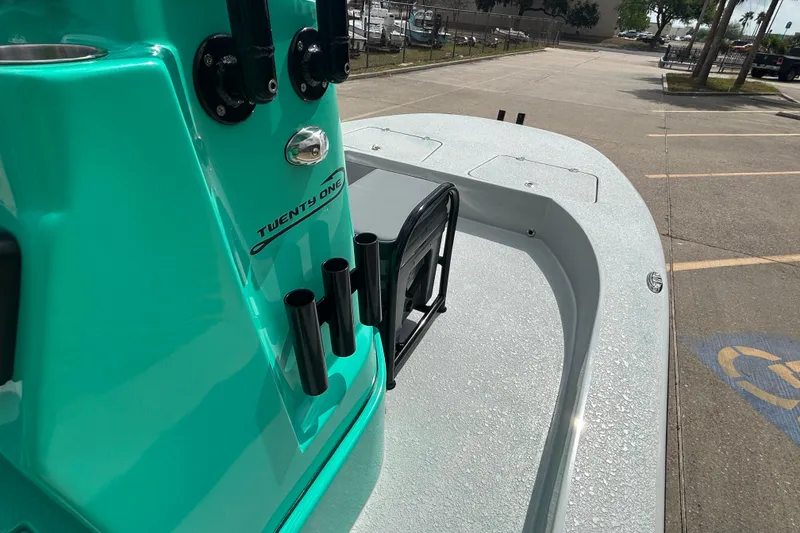 Slide: The Image of Turquoise Gulf Coast Saber Cat 2026 boat with rod holders and sleek deck design. - 15