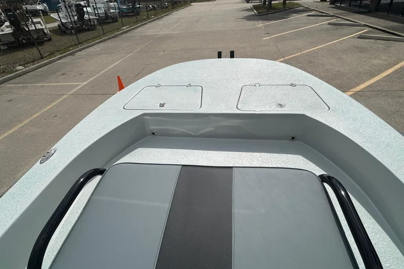 Slide: The Image of 2026 Gulf Coast Saber Cat boat deck in a parking lot, showcasing storage compartments. - 16