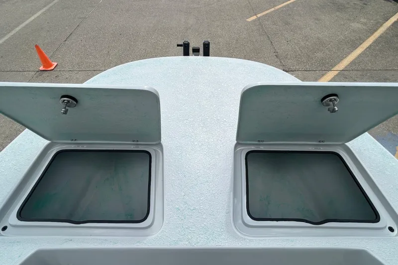 Slide: The Image of Open storage compartments on 2026 Gulf Coast Saber Cat boat deck. - 17