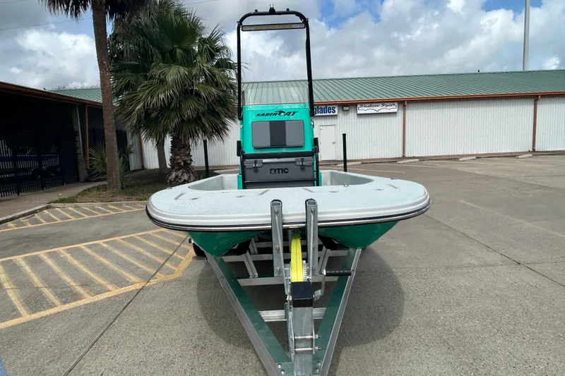 Slide: The Image of 2026 Gulf Coast Saber Cat boat on trailer, parked outdoors. - 3