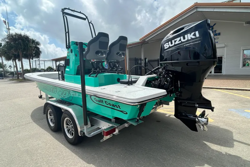 Slide: The Image of 2026 Gulf Coast Saber Cat boat with Suzuki engine on a trailer. - 8