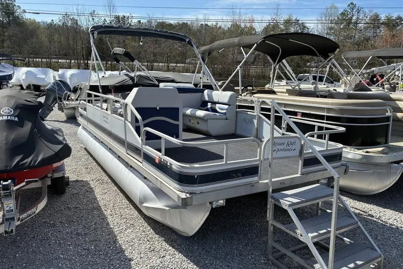 The Image of 2001 Leisure Kraft 20 Fish and Cruise pontoon boat in a marina setting. - 1