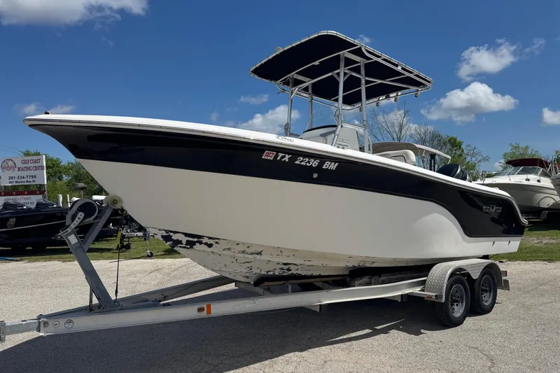 The Image of 2008 Sea Fox 216 Center Console boat on trailer under blue sky. - 1