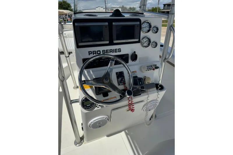 Slide: The Image of 2008 Sea Fox 216 Center Console boat dashboard with steering wheel and navigation instruments. - 11