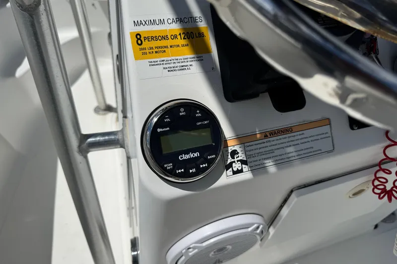 Slide: The Image of 2008 Sea Fox 216 Center Console dashboard with Clarion audio system and capacity warning. - 12