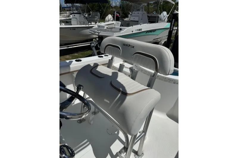 Slide: The Image of 2008 Sea Fox 216 Center Console boat interior with cushioned seating and steering wheel. - 15