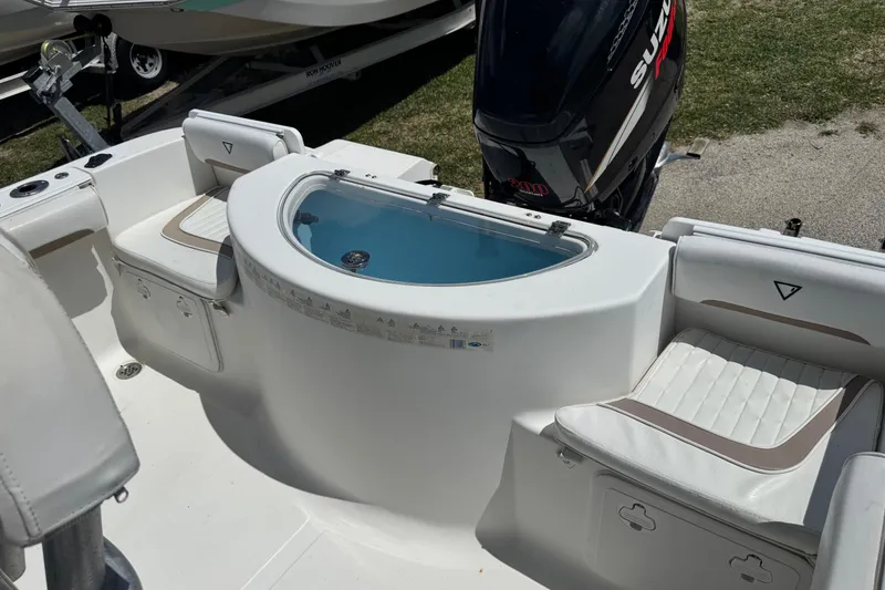Slide: The Image of 2008 Sea Fox 216 Center Console boat interior with seating and motor. - 18