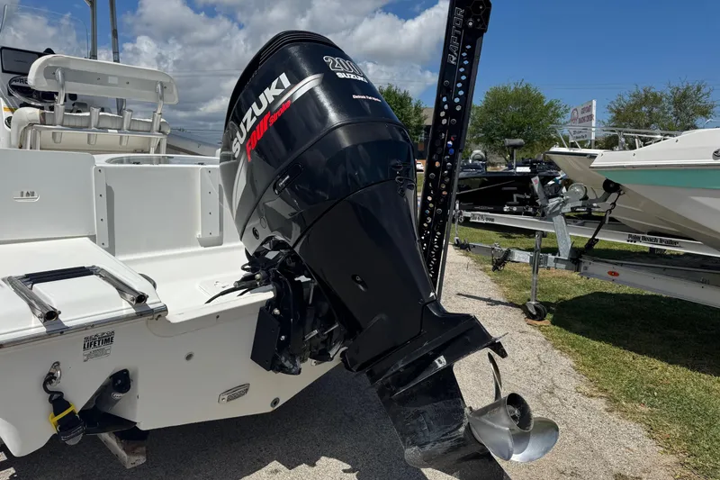 Slide: The Image of 2008 Sea Fox 216 Center Console with Suzuki outboard motor, parked on a trailer. - 2