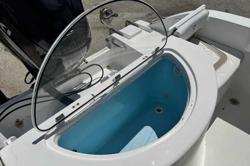 Slide: The Image of Livewell on a 2008 Sea Fox 216 Center Console boat, featuring a clear lid and blue interior. - 21