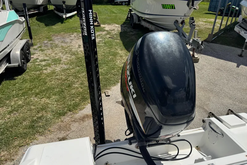 Slide: The Image of Outboard motor on a 2008 Sea Fox 216 Center Console boat, parked on grass. - 22