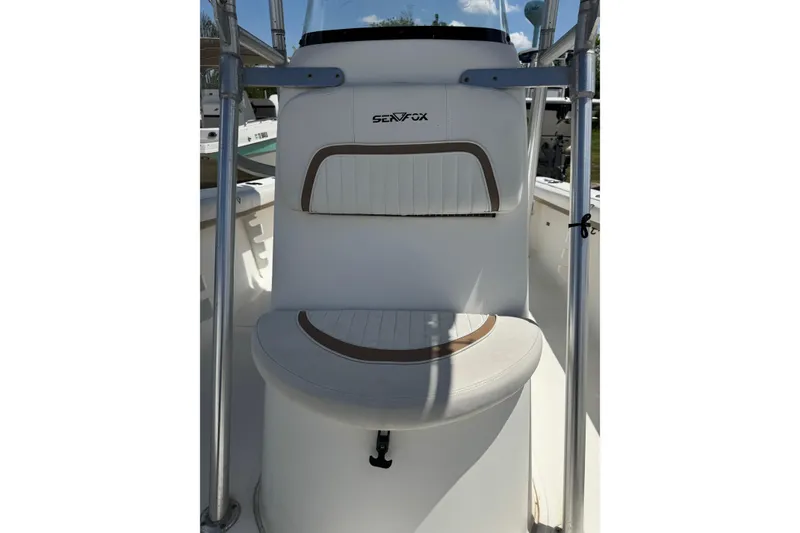 Slide: The Image of 2008 Sea Fox 216 Center Console boat seat with white and brown upholstery. - 8