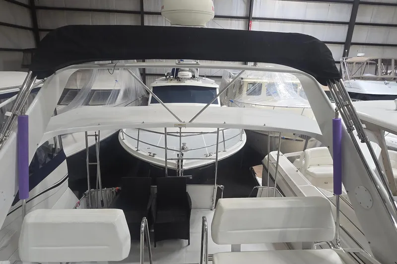 Slide: The Image of 1999 Carver 326 Aft Cabin Motor Yacht in storage, surrounded by other boats. - 10