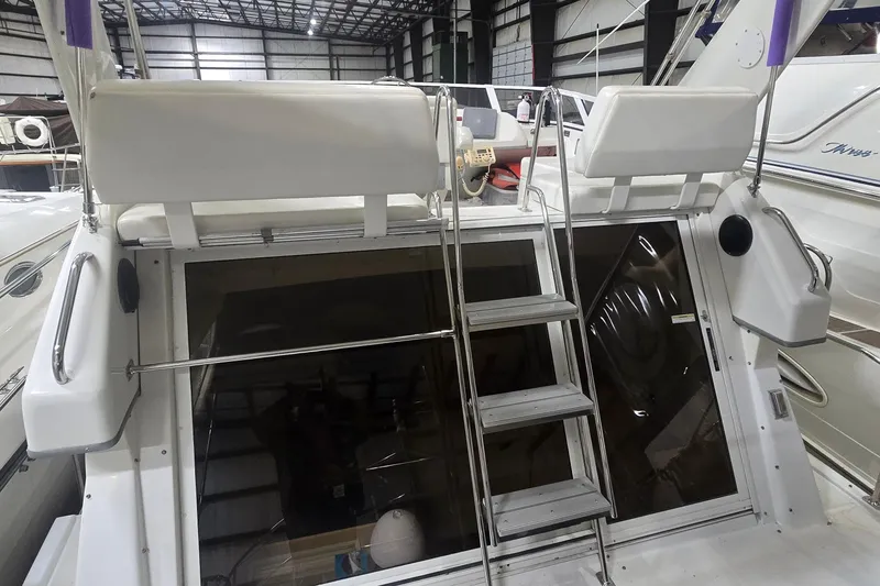 Slide: The Image of 1999 Carver 326 Aft Cabin Motor Yacht in storage, rear view with ladder and seating. - 14