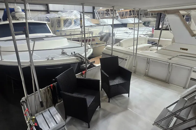 Slide: The Image of 1999 Carver 326 Aft Cabin Motor Yacht in marina with wicker chairs on deck. - 15