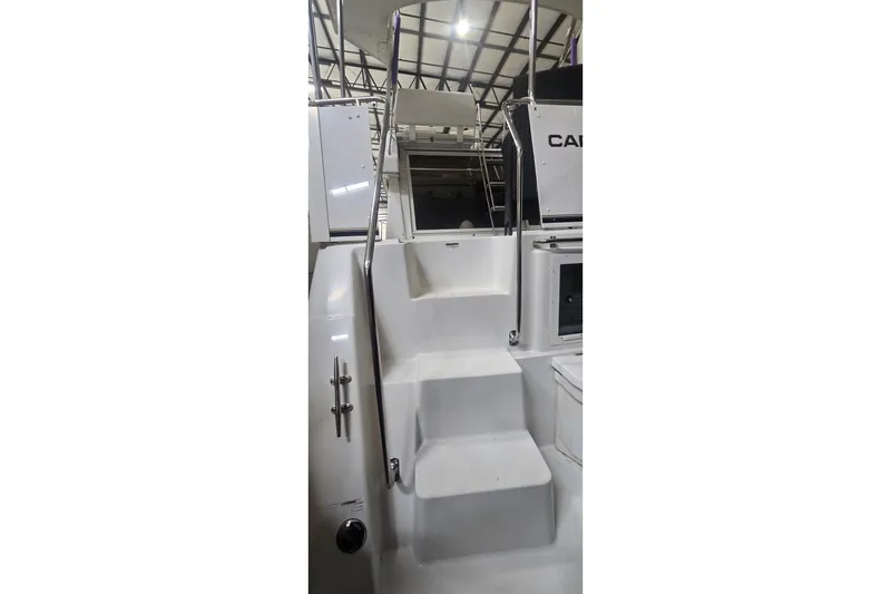 Slide: The Image of 1999 Carver 326 Aft Cabin Motor Yacht interior stairs with railing, showcasing sleek design. - 19