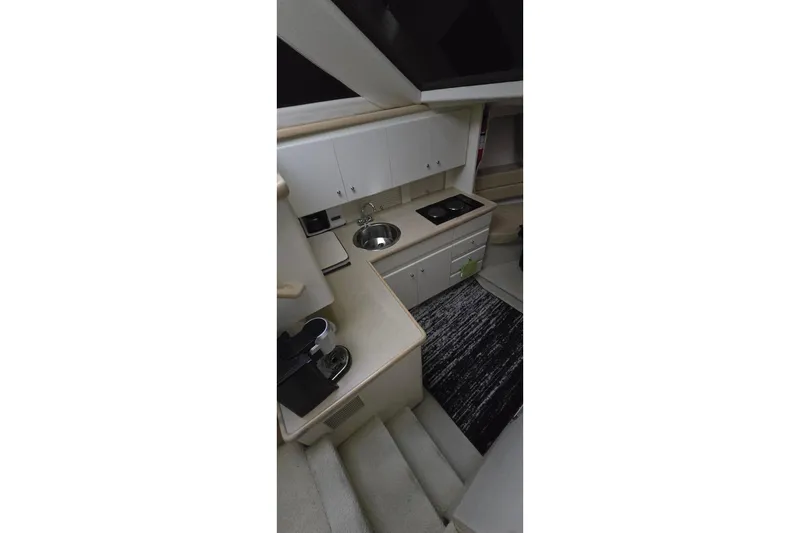 Slide: The Image of 1999 Carver 326 Aft Cabin Motor Yacht interior kitchen with sink and stove. - 21