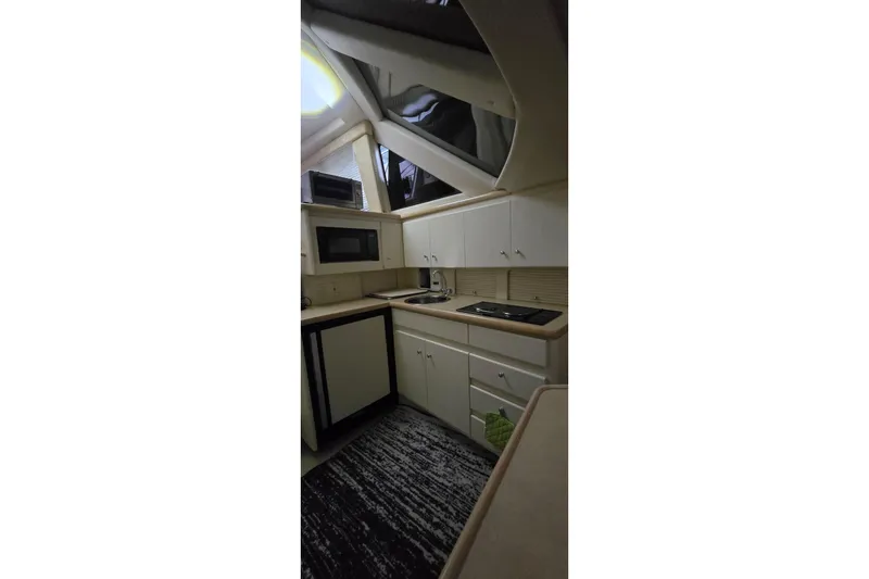 Slide: The Image of Interior of 1999 Carver 326 Aft Cabin Motor Yacht kitchen with appliances and cabinets. - 22