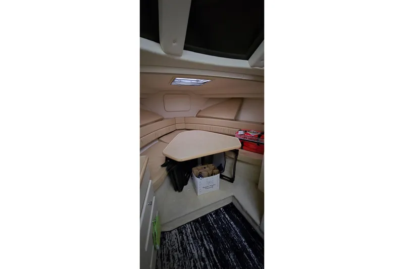 Slide: The Image of Interior of 1999 Carver 326 Aft Cabin Motor Yacht with seating and table. - 24