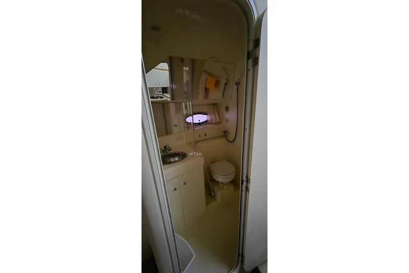 Slide: The Image of Bathroom interior of 1999 Carver 326 Aft Cabin Motor Yacht, featuring sink and toilet. - 25