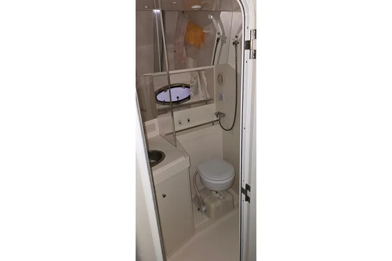 Slide: The Image of 1999 Carver 326 Aft Cabin Motor Yacht bathroom with sink, toilet, and shower. - 26