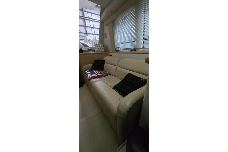 Slide: The Image of Interior of 1999 Carver 326 Aft Cabin Motor Yacht with beige sofa and cushions. - 30