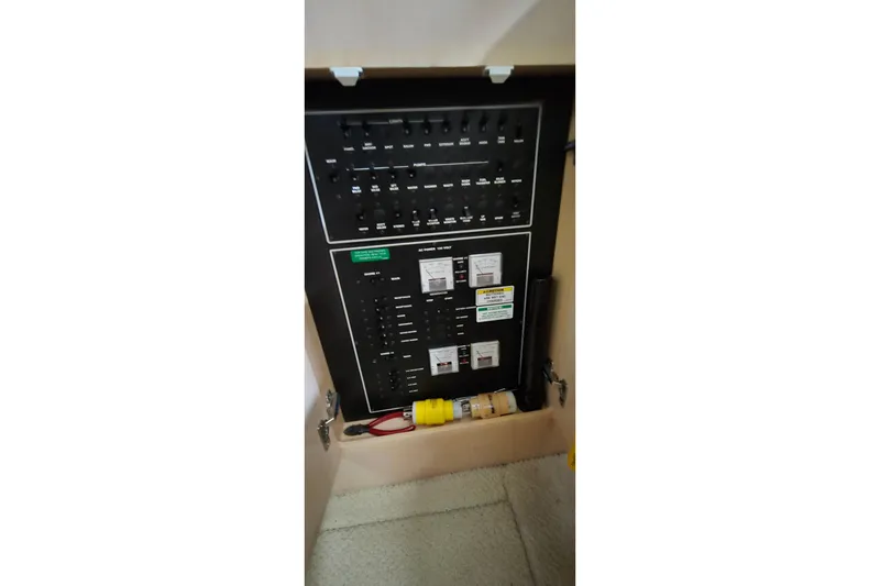 Slide: The Image of Electrical panel of 1999 Carver 326 Aft Cabin Motor Yacht, featuring switches and circuit breakers. - 31