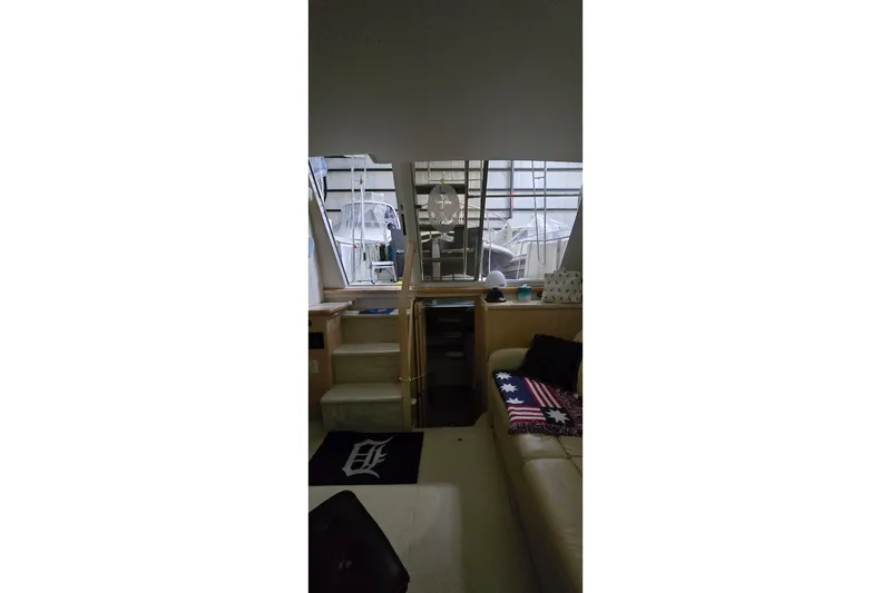 Slide: The Image of Interior of 1999 Carver 326 Aft Cabin Motor Yacht with cozy seating and nautical decor. - 33