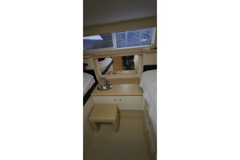 Slide: The Image of Interior of 1999 Carver 326 Aft Cabin Motor Yacht with sink and seating area. - 35