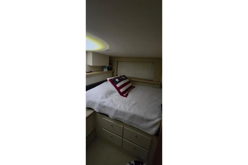 Slide: The Image of Cozy bedroom in 1999 Carver 326 Aft Cabin Motor Yacht with American flag pillow. - 36