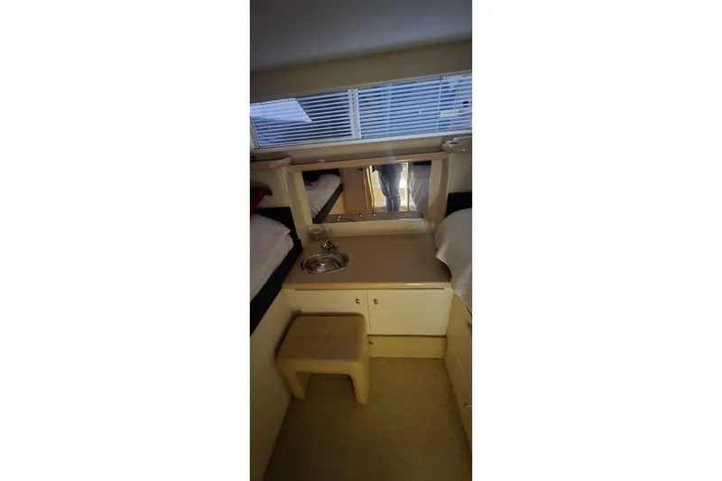 Slide: The Image of 1999 Carver 326 Aft Cabin Motor Yacht interior with vanity and seating area. - 38