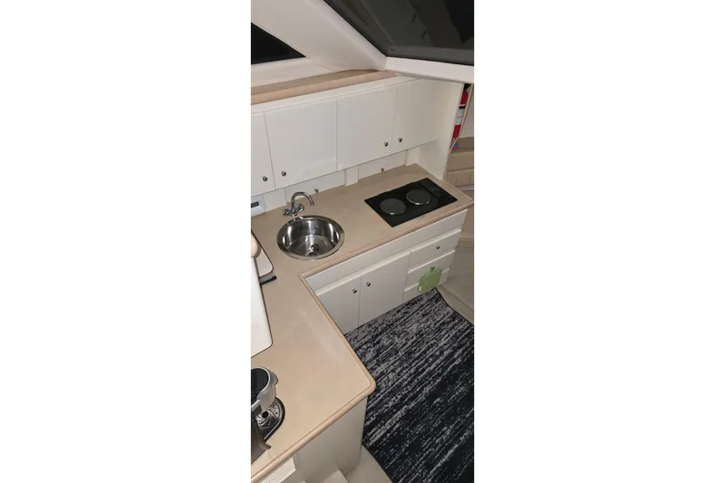 Slide: The Image of Compact kitchen area in a 1999 Carver 326 Aft Cabin Motor Yacht. - 41