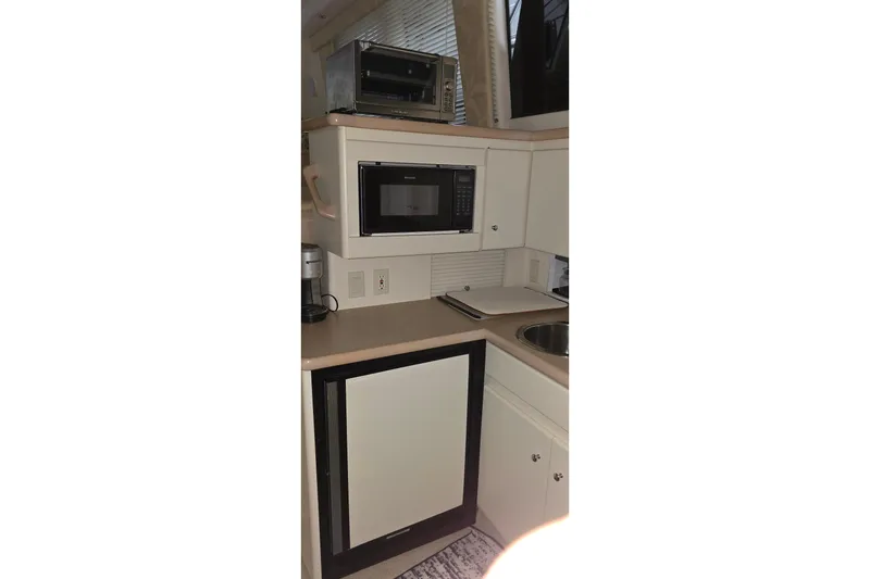 Slide: The Image of Compact kitchen area in a 1999 Carver 326 Aft Cabin Motor Yacht with appliances. - 42