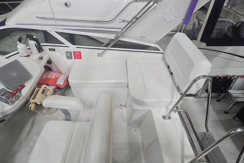 Slide: The Image of 1999 Carver 326 Aft Cabin Motor Yacht interior with seating and safety equipment. - 9