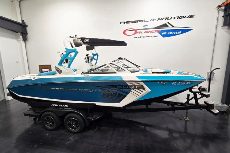 The Image of 2017 Nautique Super Air Nautique G23 boat in showroom, blue and white design. - 0