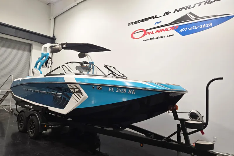 Slide: The Image of 2017 Nautique Super Air Nautique G23 boat on trailer in showroom. - 10
