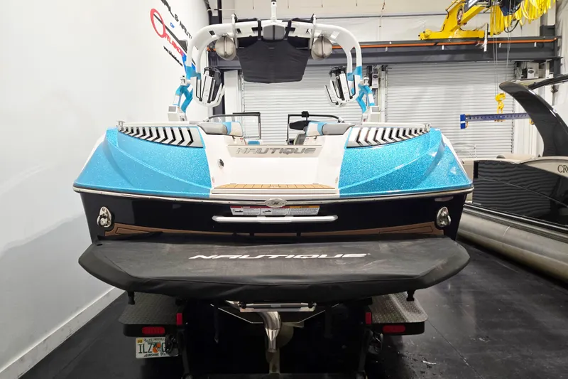 Slide: The Image of 2017 Nautique Super Air Nautique G23 boat in showroom, rear view. - 13