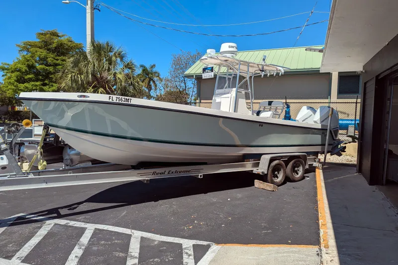 Slide: The Image of 2005 SeaVee 290B boat on trailer, parked outdoors under clear blue sky. - 1