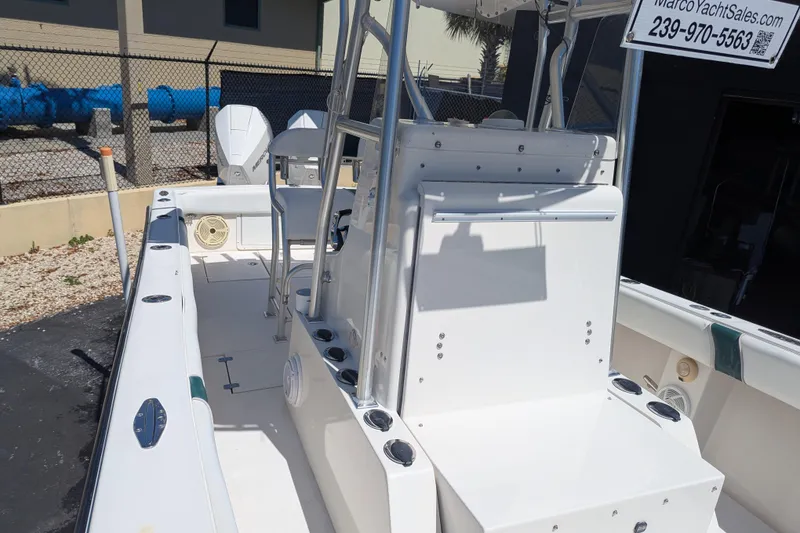 Slide: The Image of 2005 SeaVee 290B boat interior with seating and rod holders, displayed outdoors. - 19