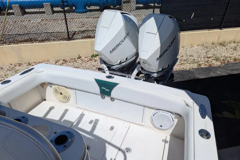 Slide: The Image of 2005 SeaVee 290B boat with dual Mercury outboard engines, docked outdoors. - 23